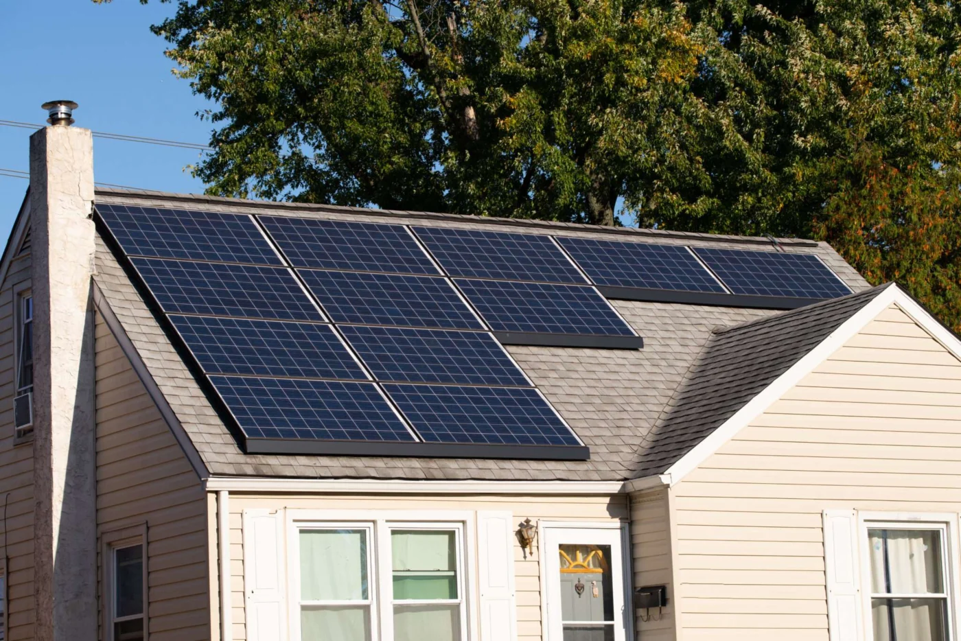 Solar Panels Outfitted Onto Roof Of Tan House For Backup Power