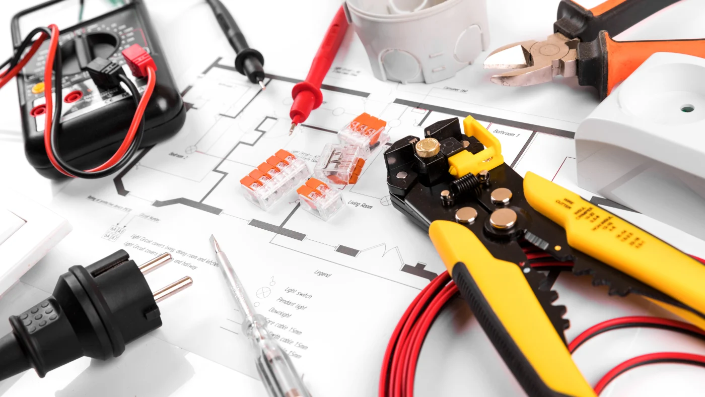 Electrical equipment and wires sit on rewiring plans