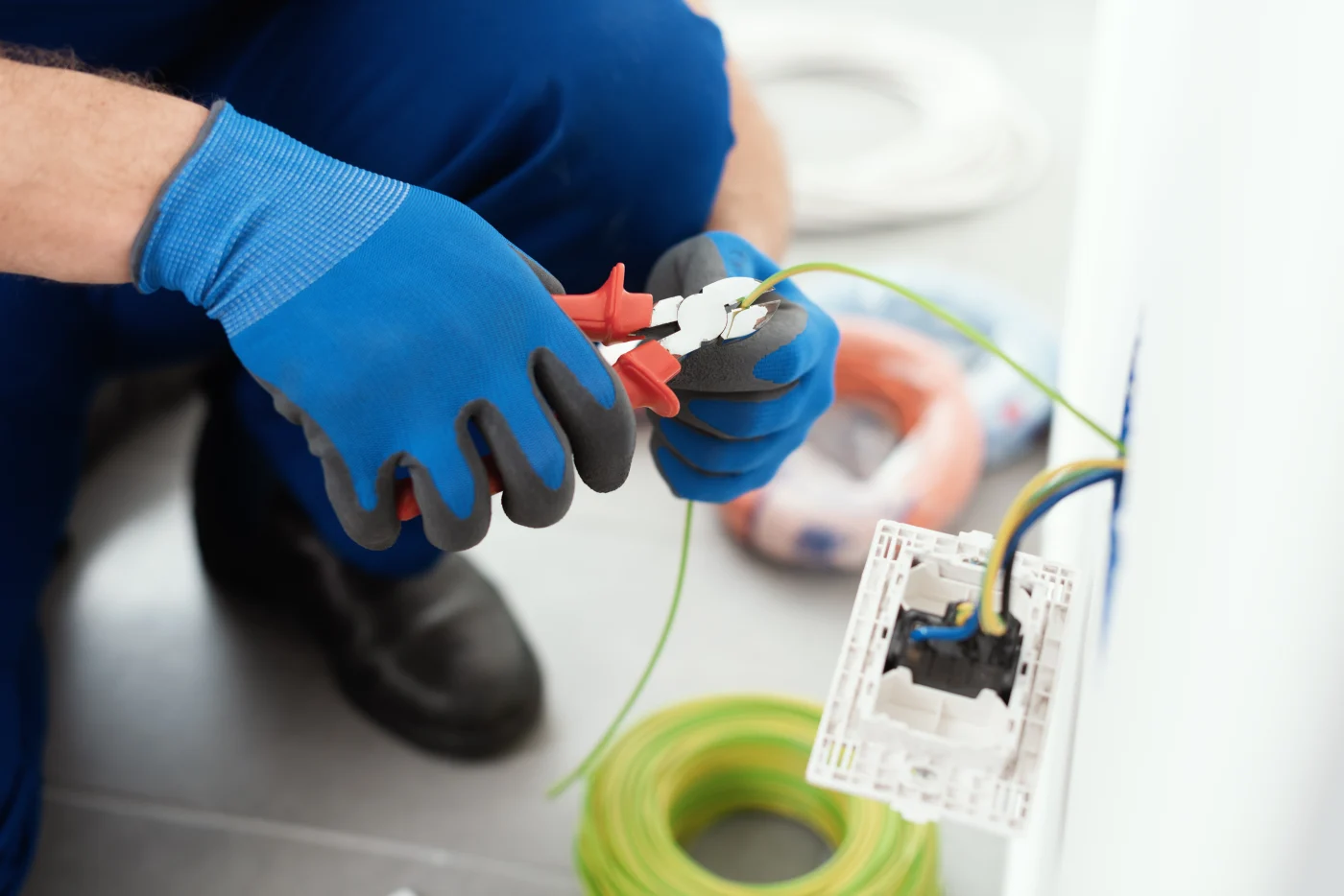 A professional electrician from Emerge Electrical in Chehalis, WA, working on a residential electrical system.