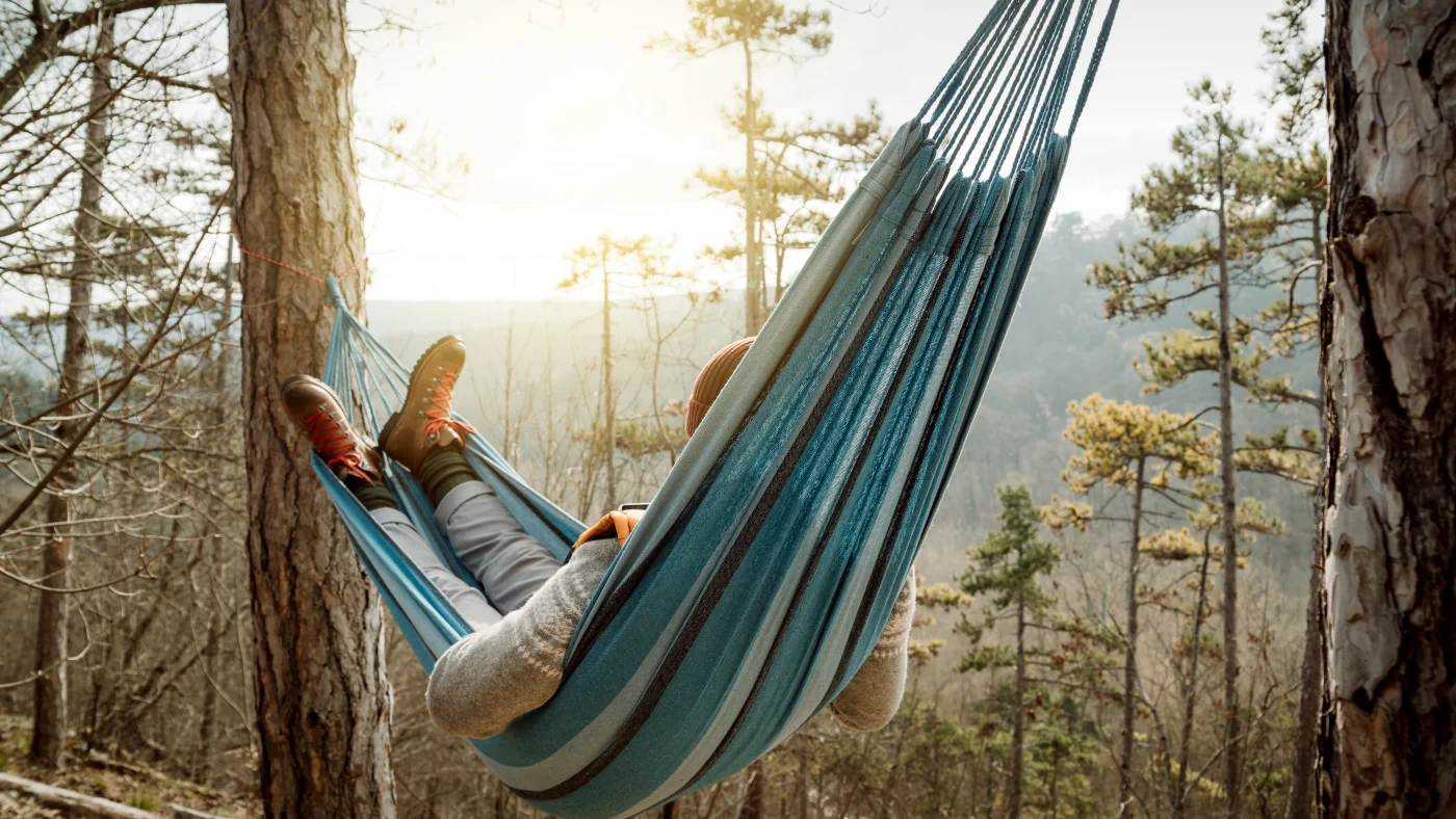 A person relaxes in a hammock with zero stress