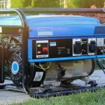 Close-up view on gas-powered generator sitting on concrete sidewalk outside