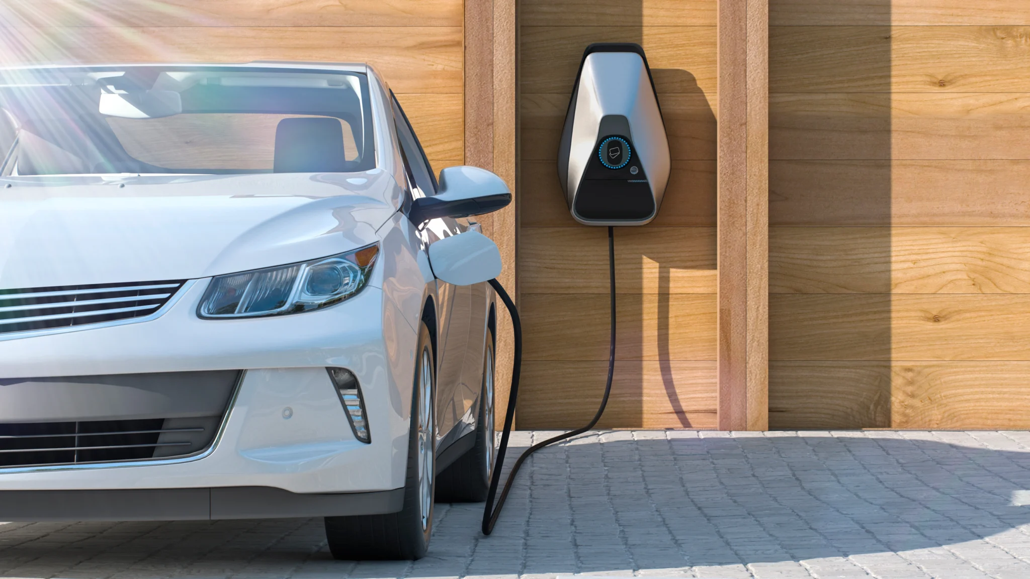 White electric car being charged in a driveway