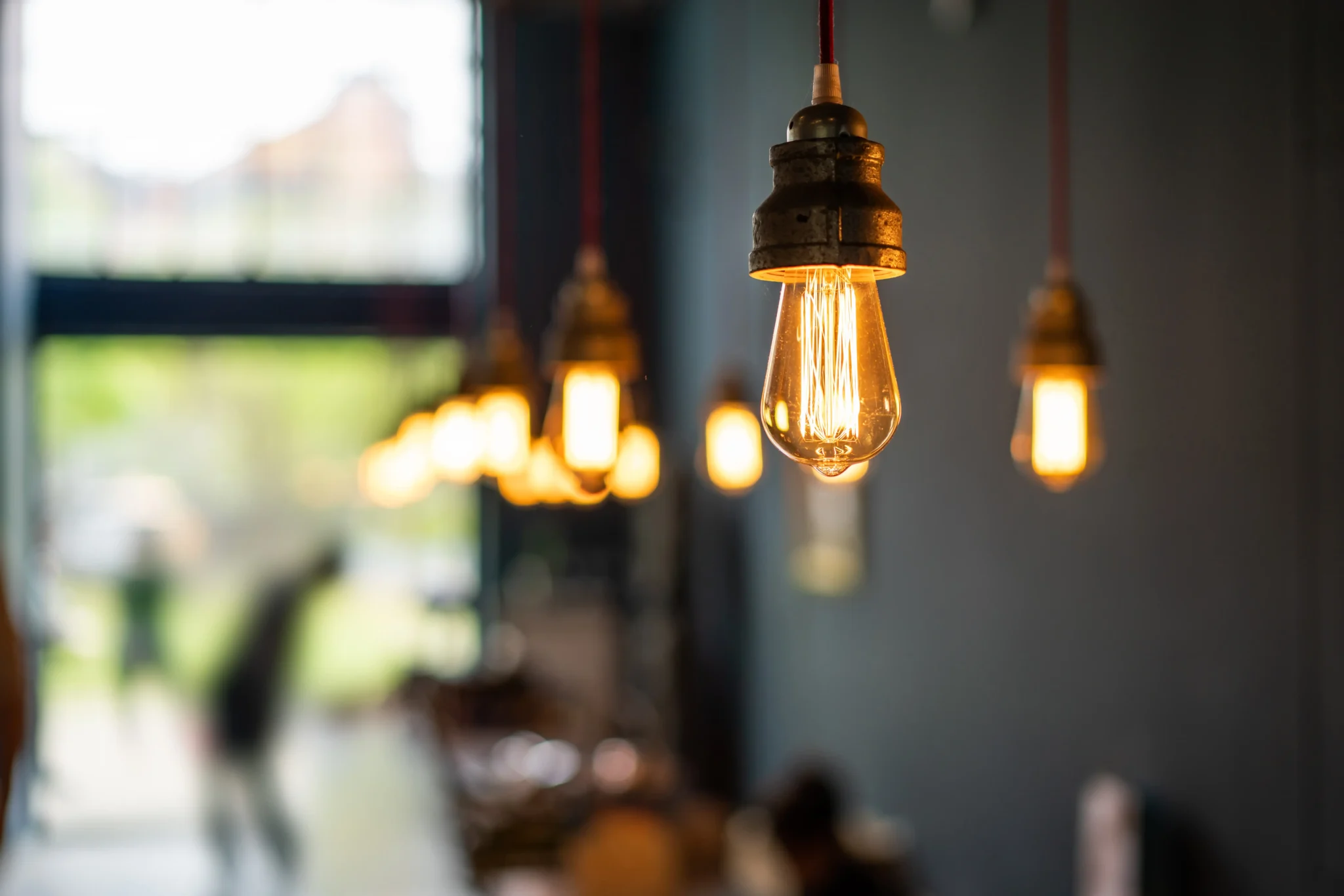Elegant pendant lights above a cozy dining room