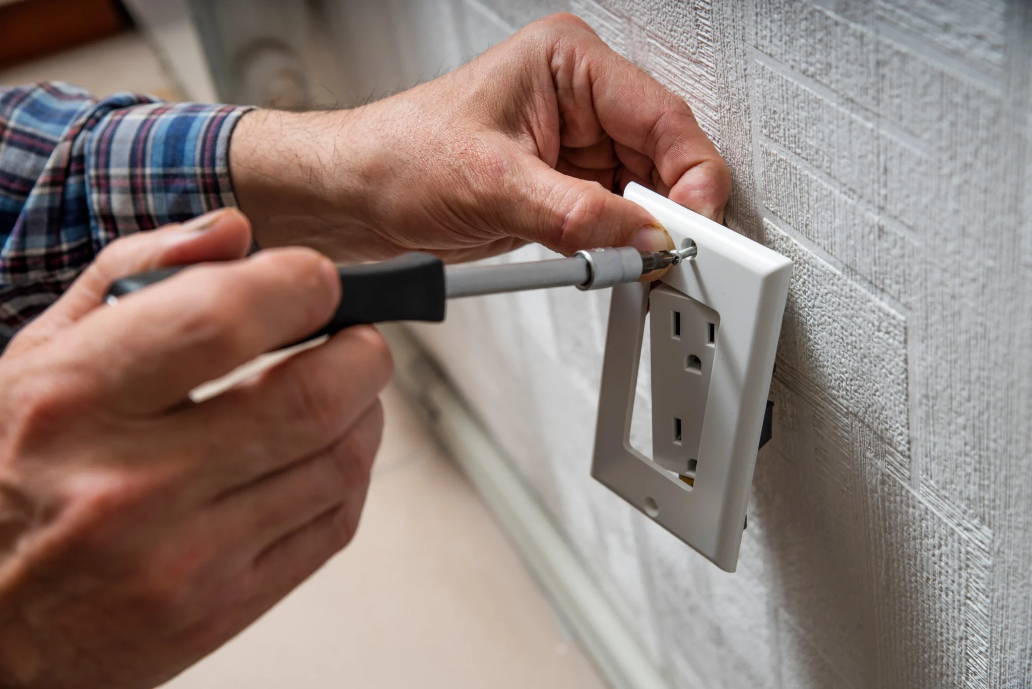Electrician installing an electrical outlet socket in Tumwater, WA | Emerge Electrical